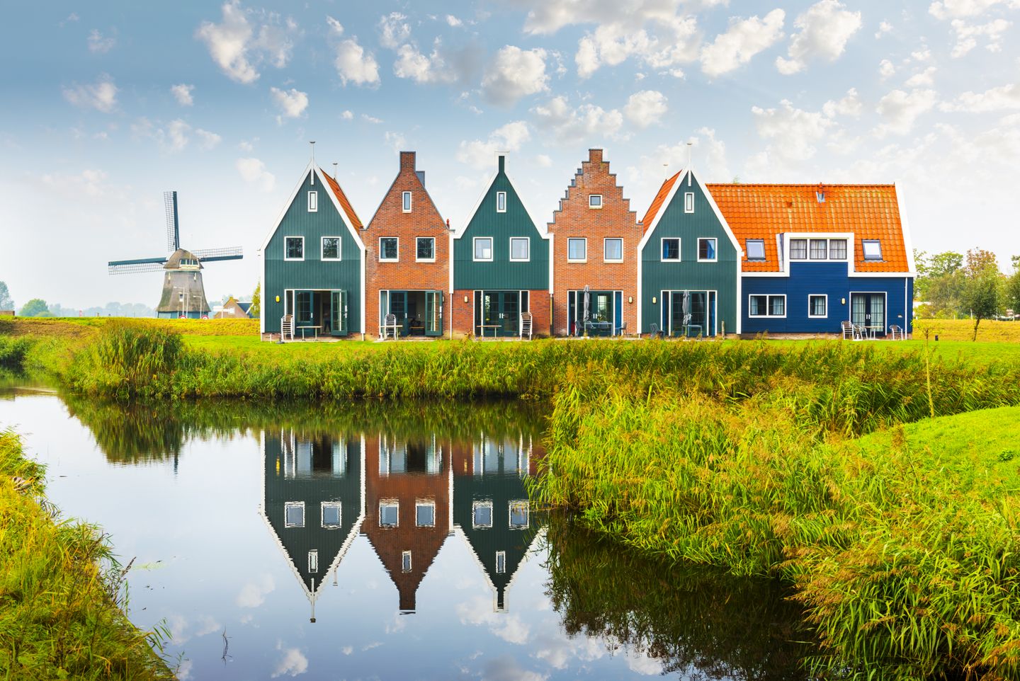 Colourful wooden houses and a windmill in Volendam, the Netherlands
