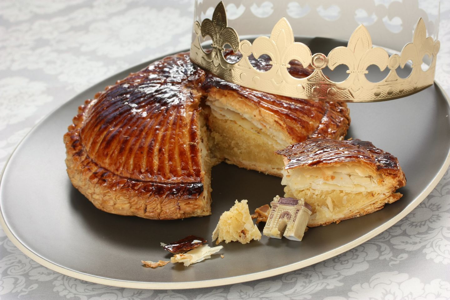 A Galette des Rois (or king cake) with a crown and figurine