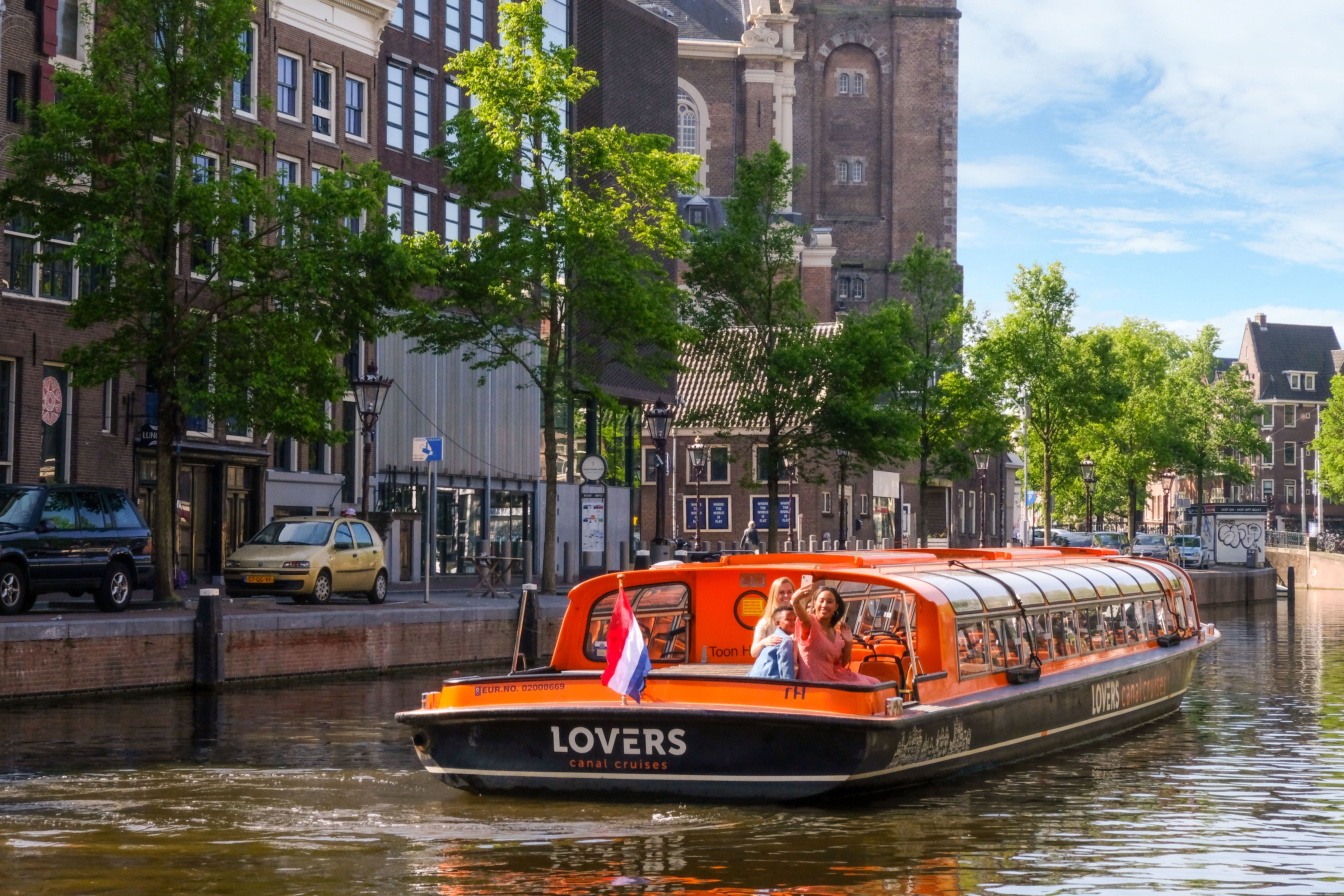 A boat cruising down Amsterdam canal